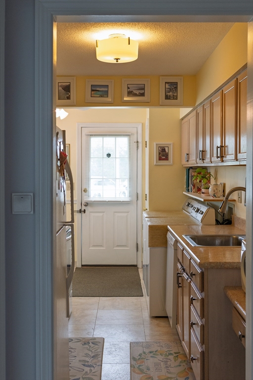 61 Outer Drive, Unit 61 Chicopee, MA 01022 - Photo 3 of 25 a kitchen that has a sink a stove and a window