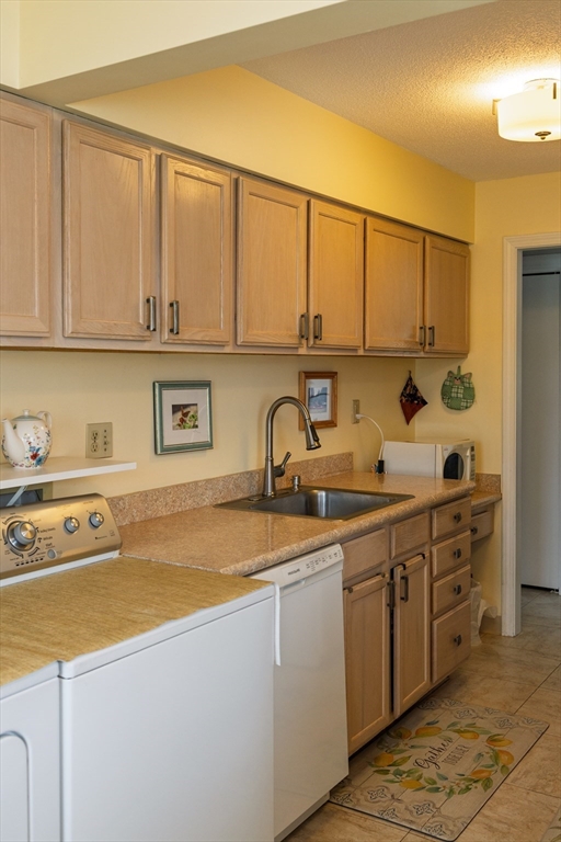 61 Outer Drive, Unit 61 Chicopee, MA 01022 - Photo 4 of 25 a kitchen with stainless steel appliances granite countertop a sink and cabinets