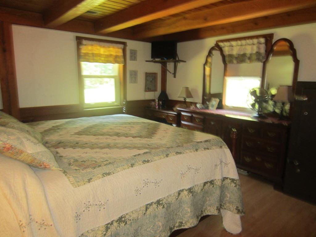 980 Walnut Plain Road Rochester, MA 02770 - Photo 25 of 31 a bedroom with a bed and large windows