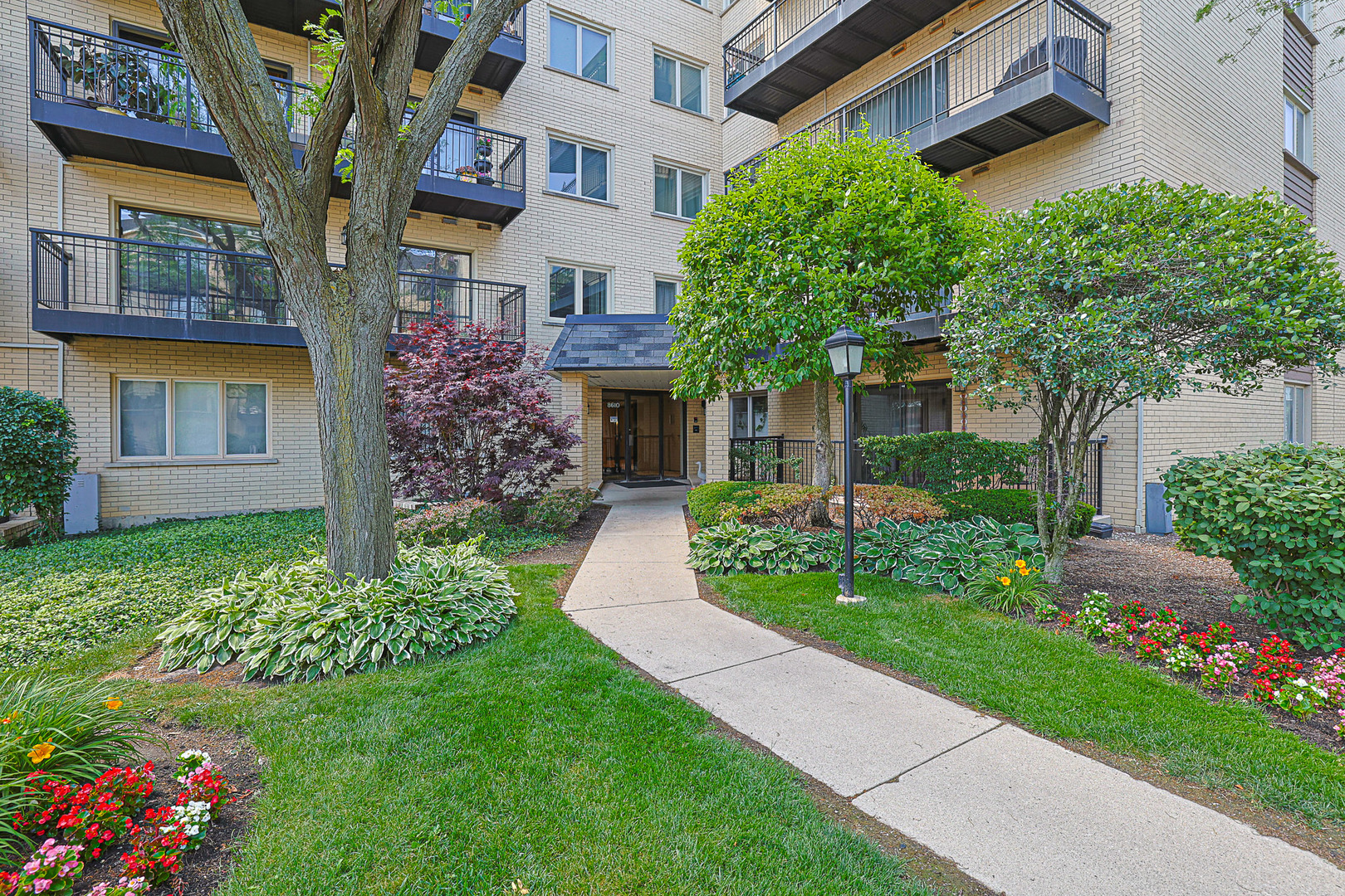 8610 Waukegan Road, Unit 506W Morton Grove, IL 60053 - Photo 1 of 1 front view of a house with a yard