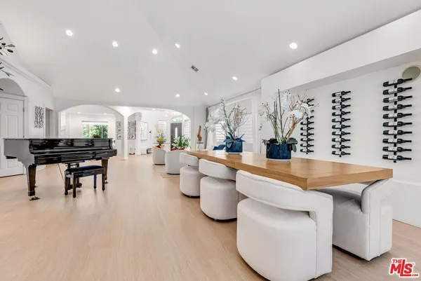 a kitchen with a sink and chairs