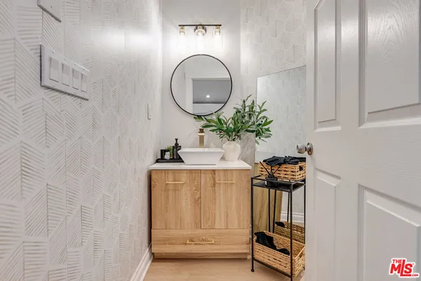 a bathroom with a sink mirror and vanity