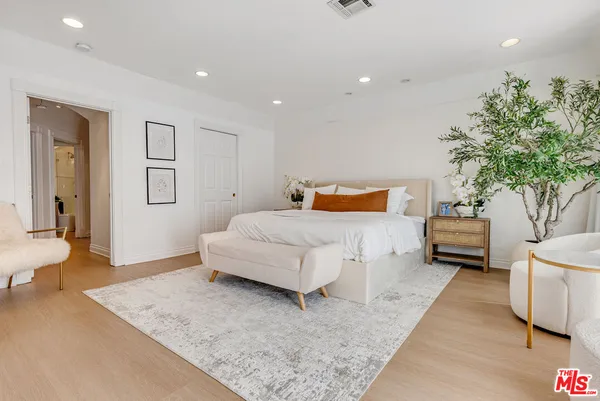 a bedroom with a large bed and a couch