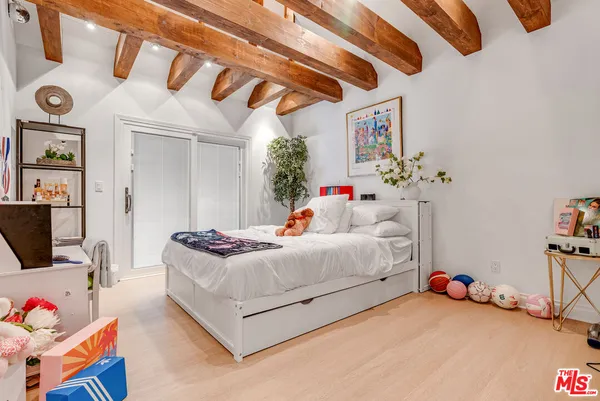 a bedroom with furniture and a chandelier