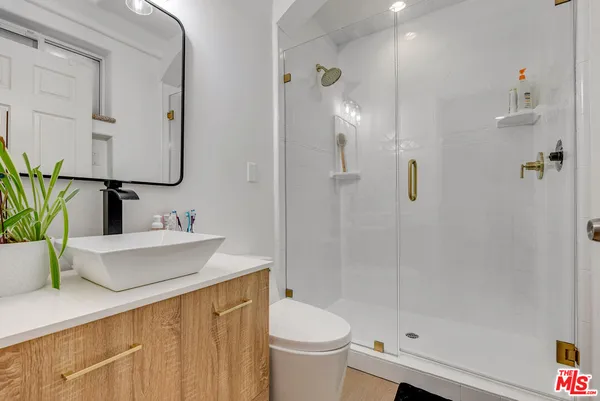 a bathroom with a sink toilet and shower