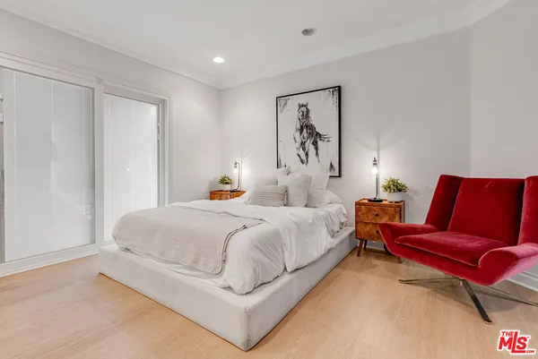 a spacious bedroom with a bed and a couch