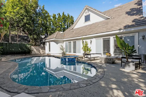 a view of a house with backyard sitting area and sitting area