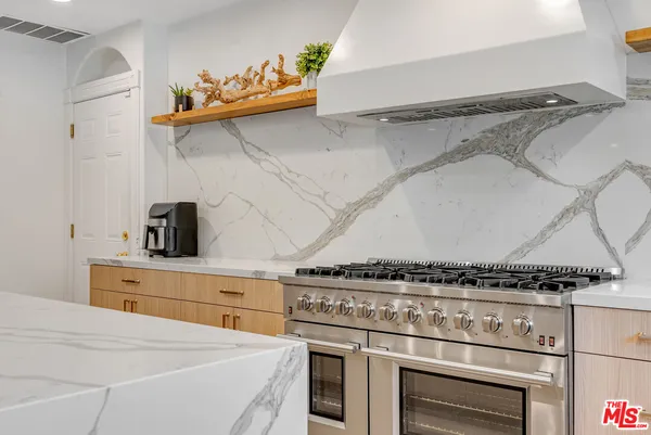 a kitchen with a stove and cabinets