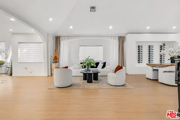 a kitchen with furniture and potted plant