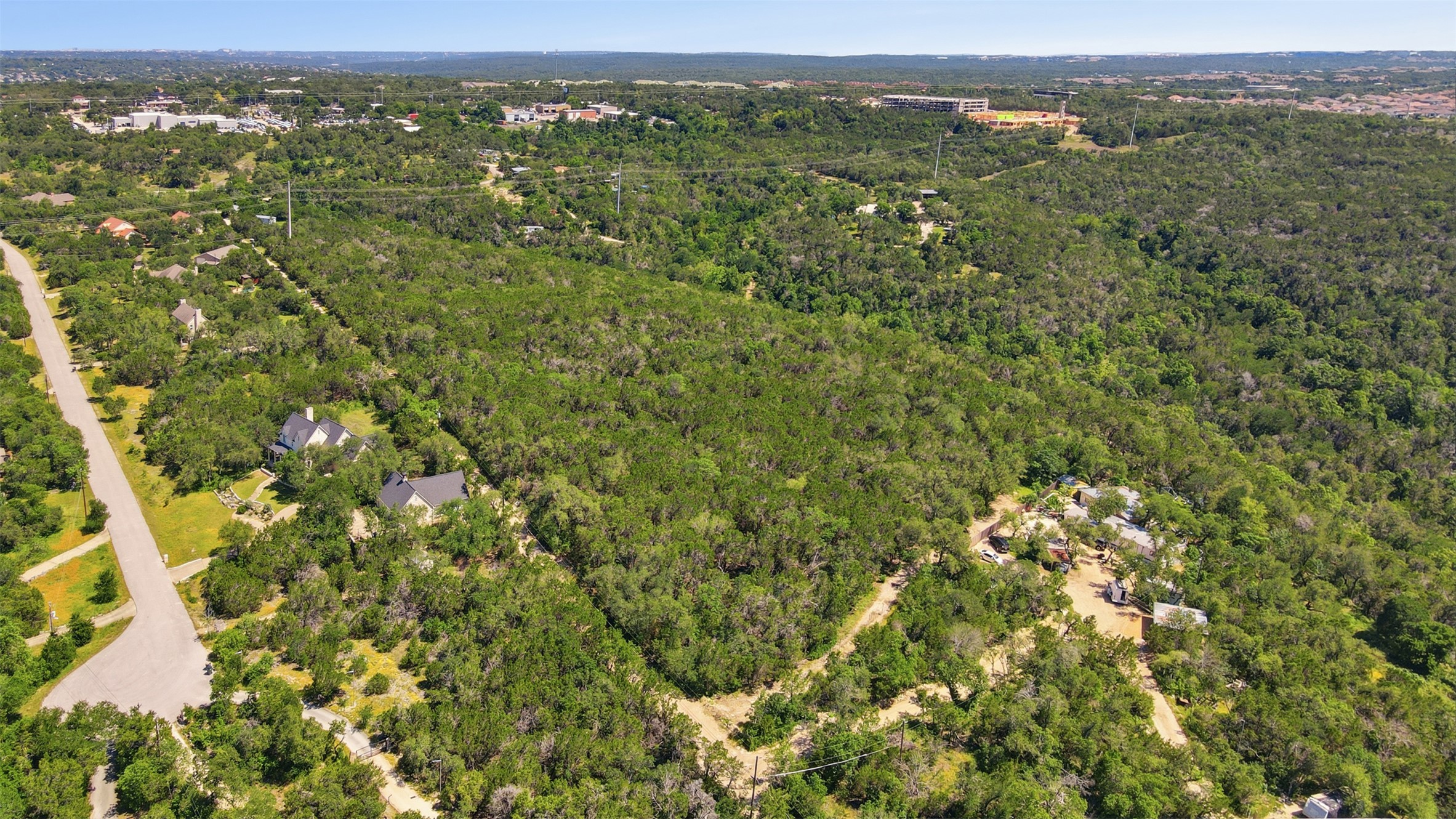 0 North Ranch Road 620 Road Austin, TX 78726 - Photo 9 of 20 an aerial view of residential houses with outdoor space and trees