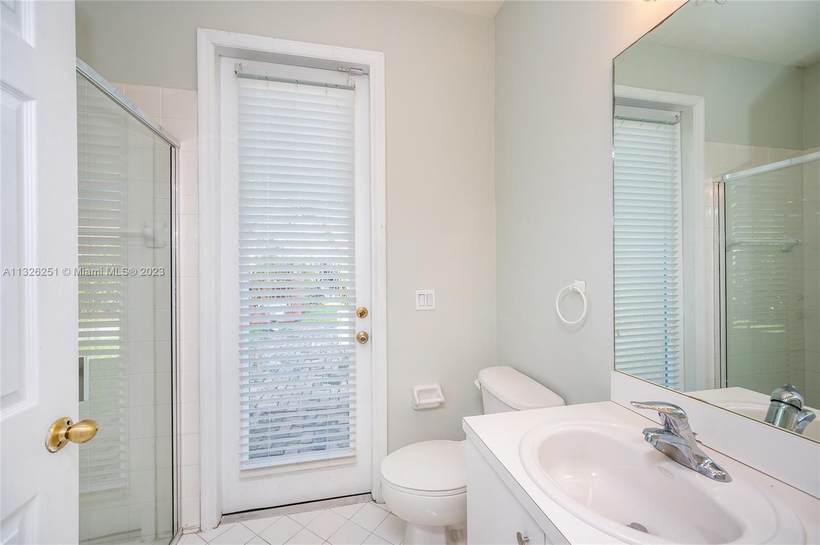 2106 Northeast 40th Road Homestead, FL 33033 - Photo 11 of 33 a bathroom with a sink a toilet and shower