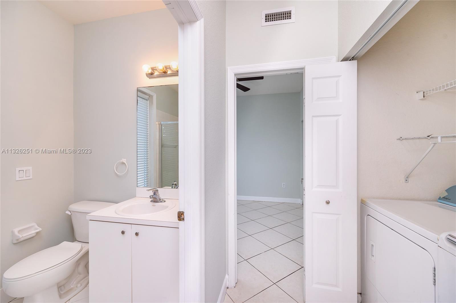 2106 Northeast 40th Road Homestead, FL 33033 - Photo 12 of 33 a bathroom with a sink a toilet and shower