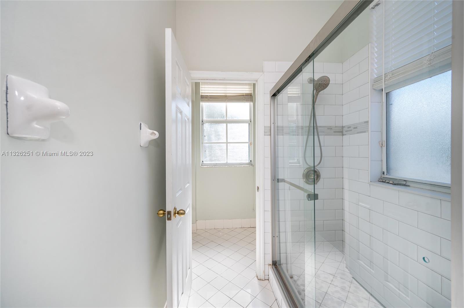 2106 Northeast 40th Road Homestead, FL 33033 - Photo 16 of 33 a bathroom with a glass shower door