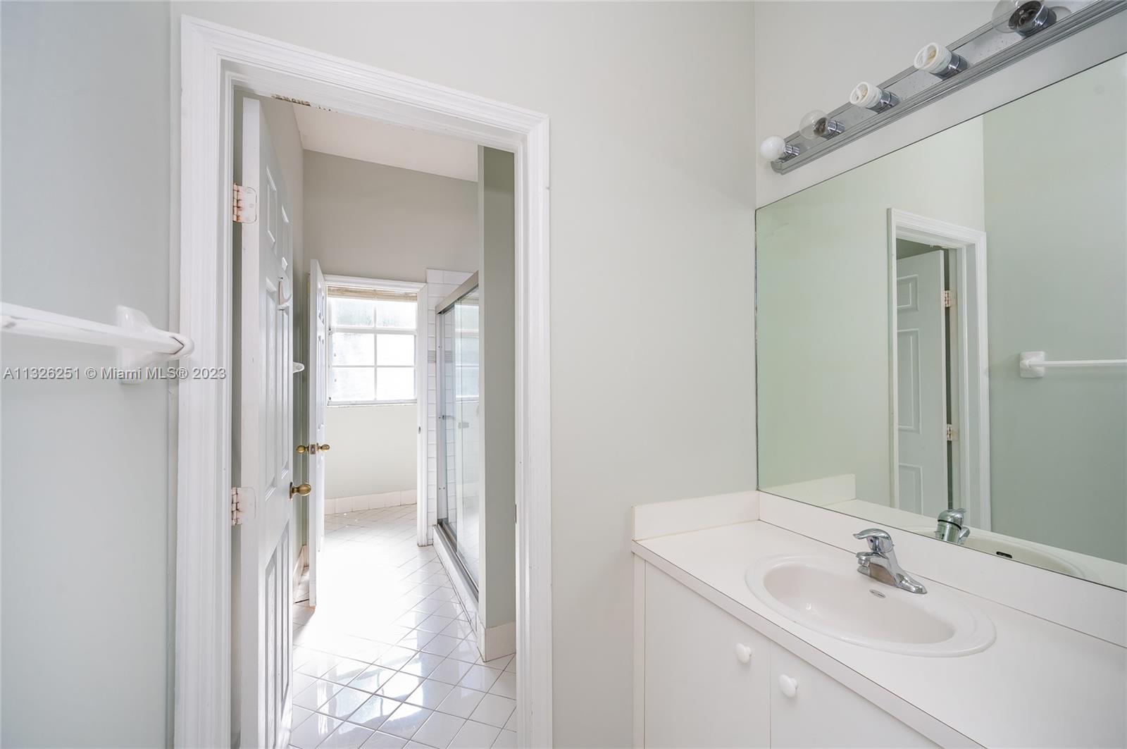 2106 Northeast 40th Road Homestead, FL 33033 - Photo 17 of 33 a bathroom with a sink and a mirror
