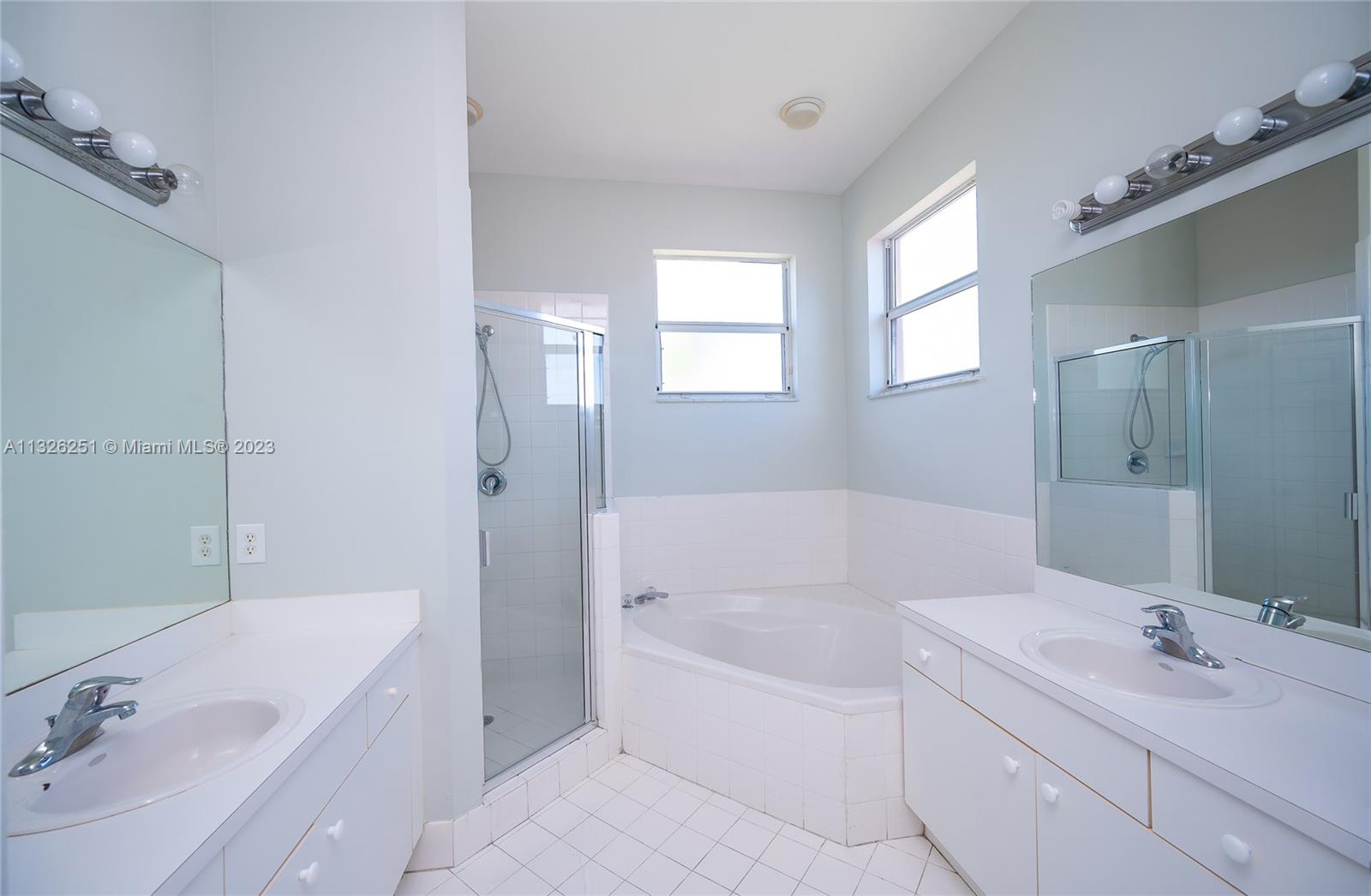 2106 Northeast 40th Road Homestead, FL 33033 - Photo 20 of 33 a bathroom with a tub sink and mirror