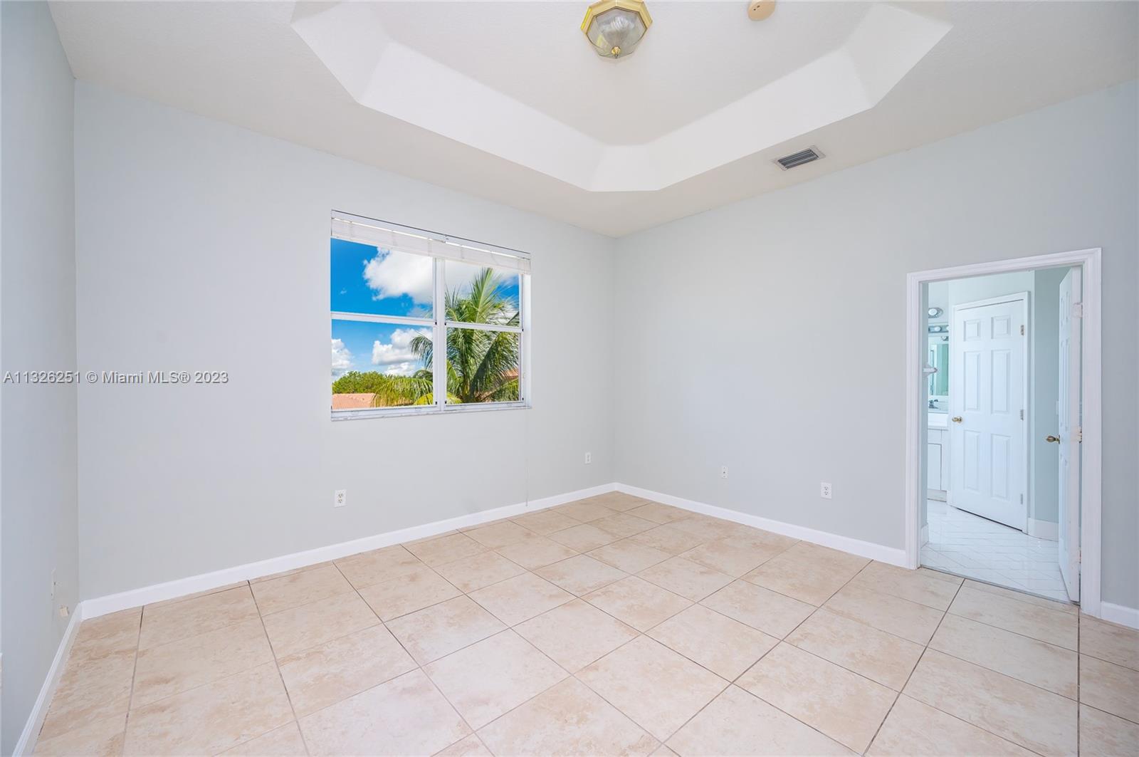 2106 Northeast 40th Road Homestead, FL 33033 - Photo 22 of 33 an empty room with windows and painted walls
