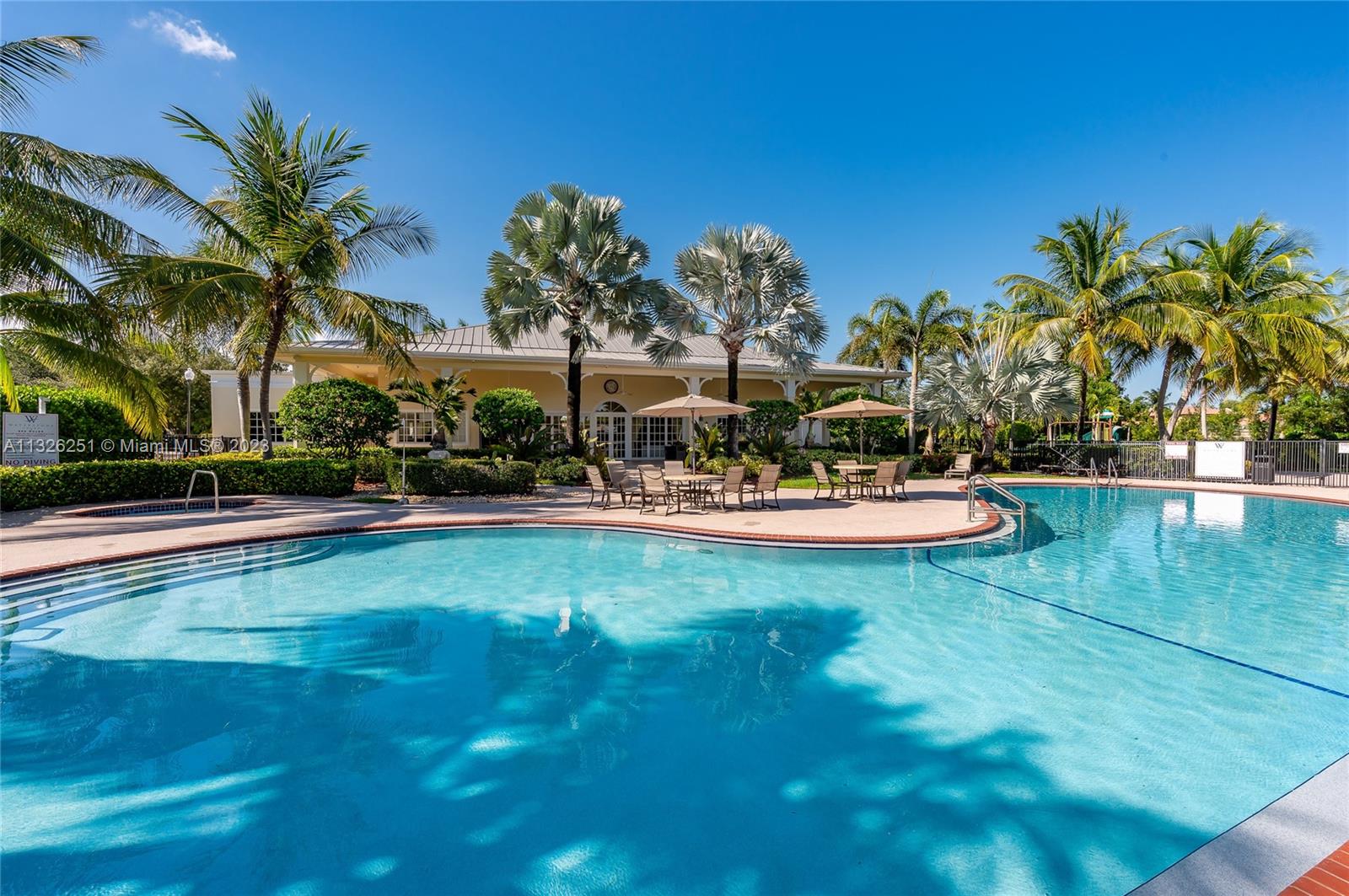 2106 Northeast 40th Road Homestead, FL 33033 - Photo 26 of 33 a view of a swimming pool with a table and chairs