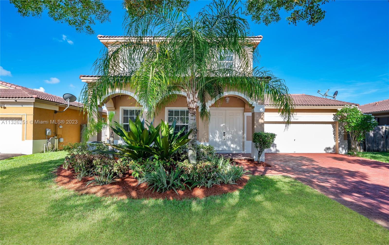 2106 Northeast 40th Road Homestead, FL 33033 - Photo 3 of 33 a front view of a house with a yard