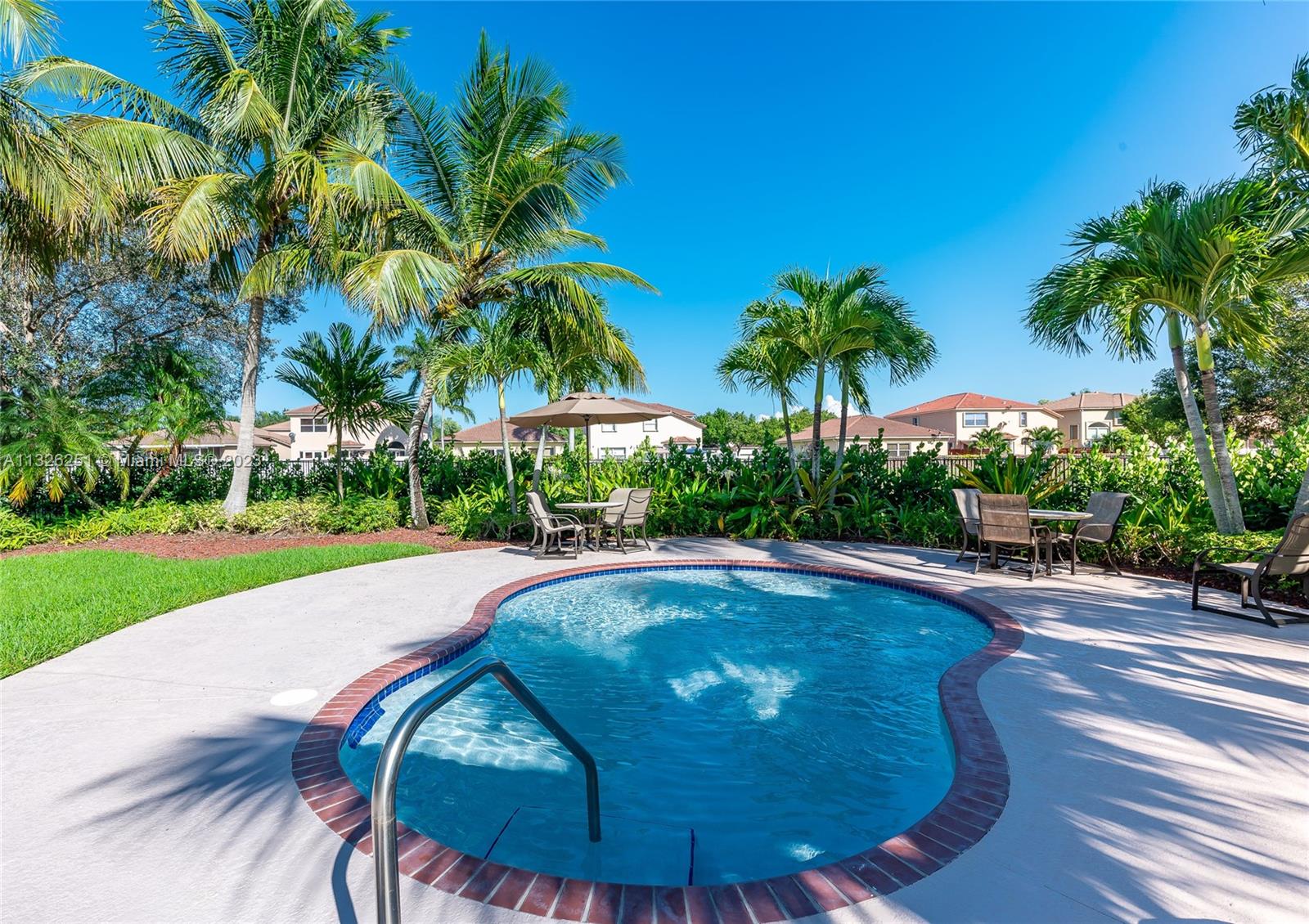 2106 Northeast 40th Road Homestead, FL 33033 - Photo 32 of 33 a view of a swimming pool with a patio and plants