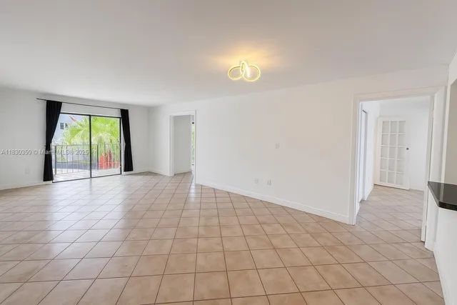 an empty room with windows and entrance