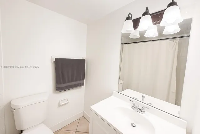 a bathroom with a sink toilet and mirror