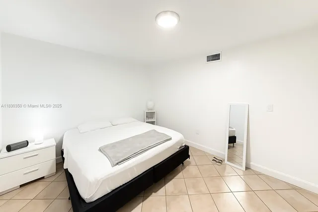 a room with a bed and white walls