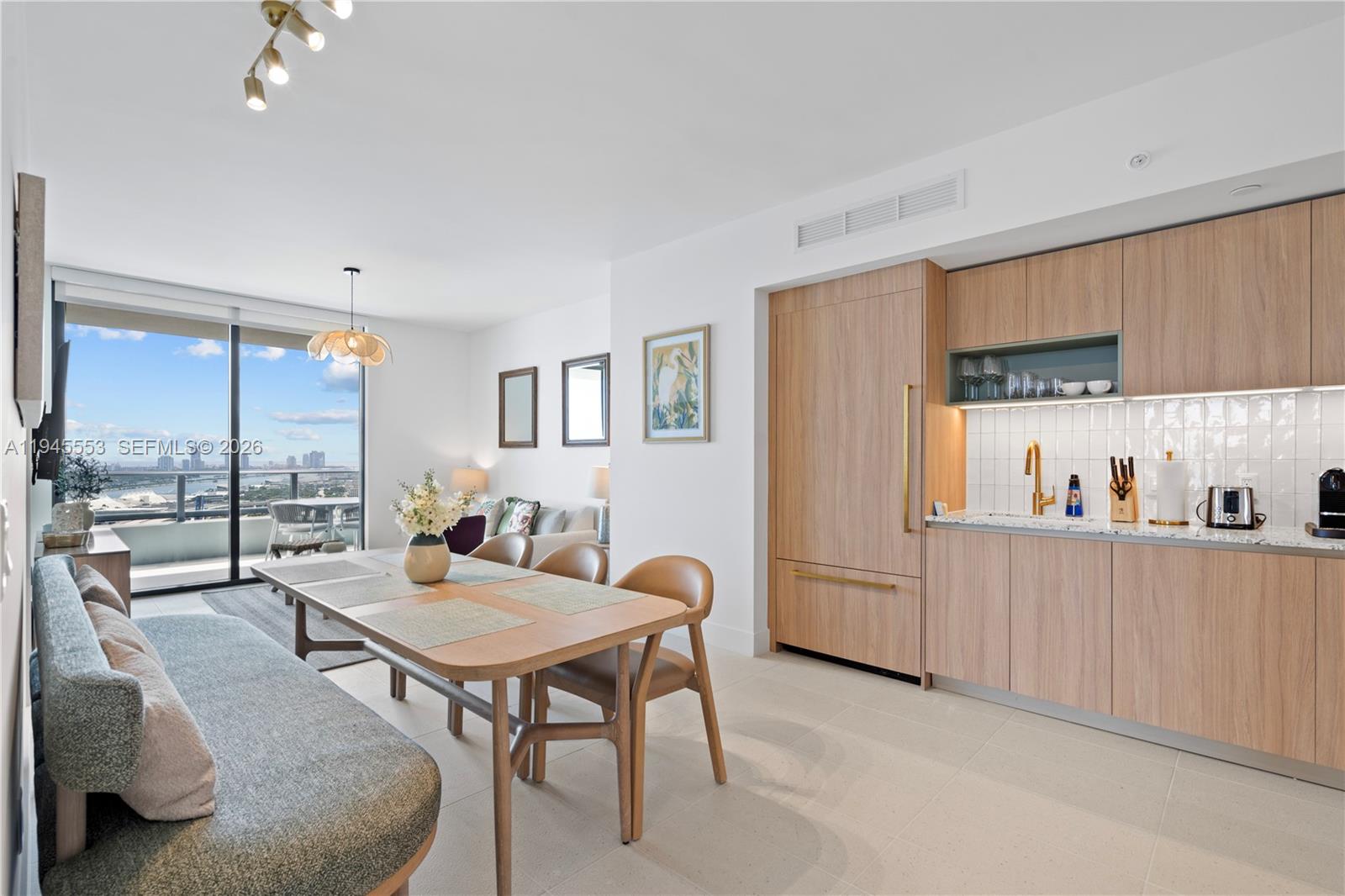 159 Northeast 6th Street, Unit 2415 Miami, FL 33132 - Photo 15 of 42 a living room with furniture and a window
