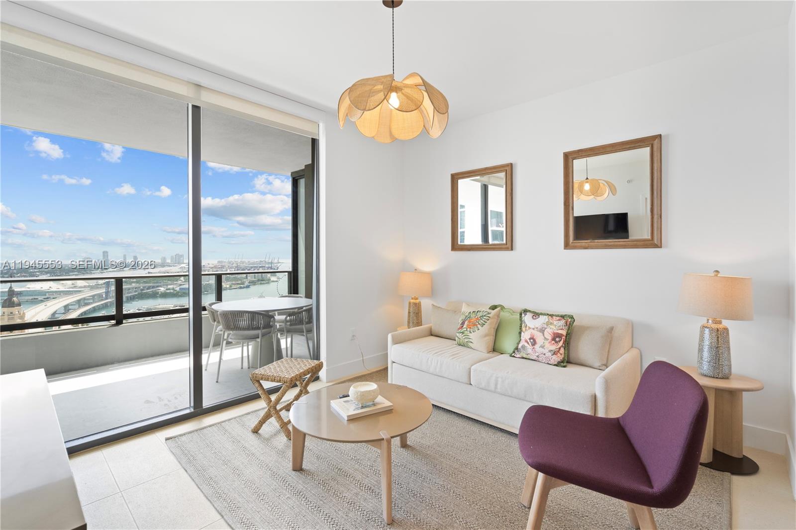 159 Northeast 6th Street, Unit 2415 Miami, FL 33132 - Photo 18 of 42 a living room with furniture and a large window
