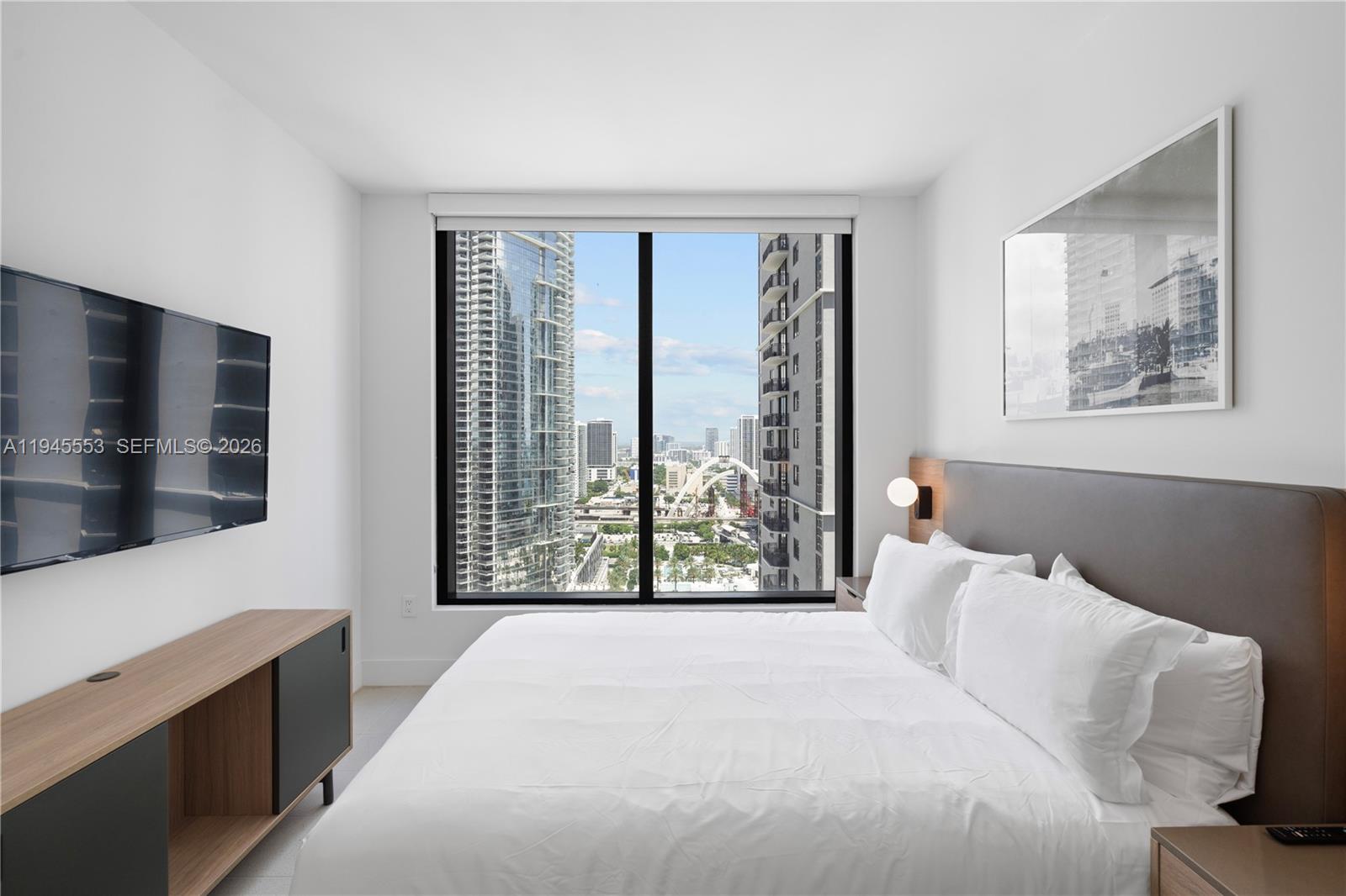 159 Northeast 6th Street, Unit 2415 Miami, FL 33132 - Photo 29 of 42 a bedroom with a large bed and a large window