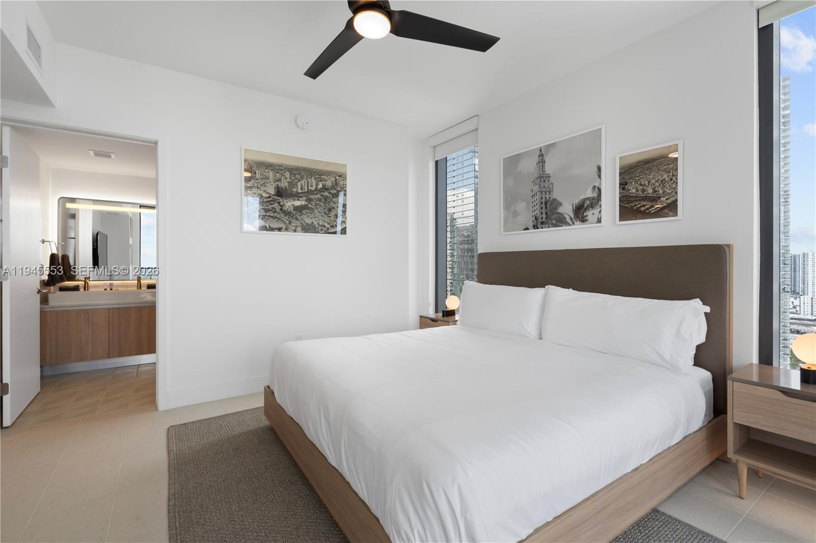 159 Northeast 6th Street, Unit 2415 Miami, FL 33132 - Photo 5 of 42 a bedroom with a bed and a view of kitchen