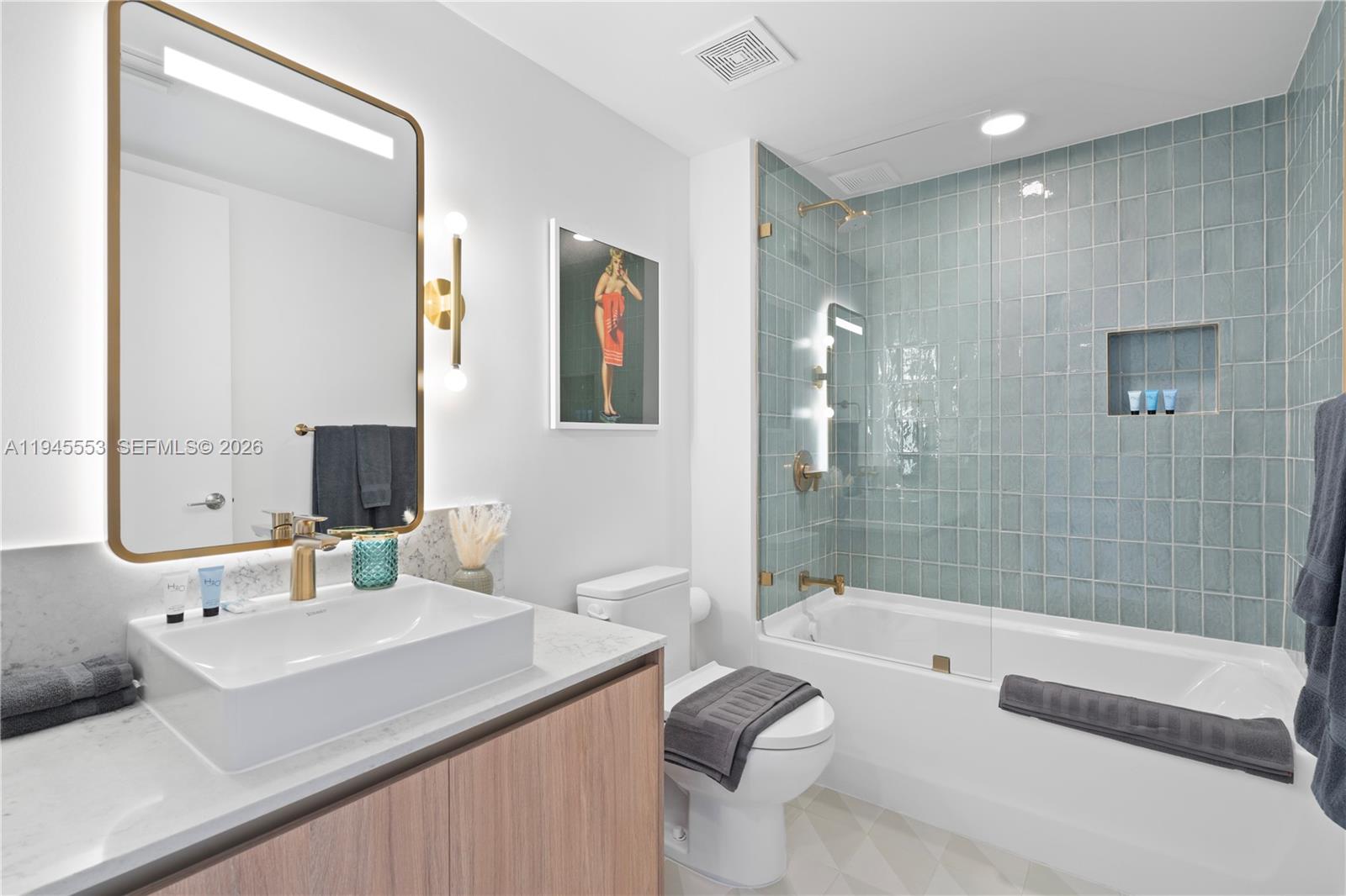 159 Northeast 6th Street, Unit 2415 Miami, FL 33132 - Photo 10 of 42 a bathroom with a sink a toilet and shower