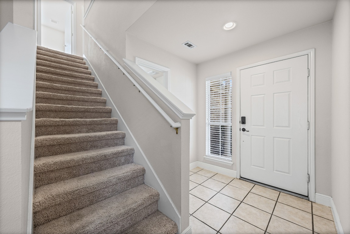 336 Celery Loop Austin, TX 78748 - Photo 10 of 32 Foyer featuring stairs, light tile patterned flooring, and recessed lighting