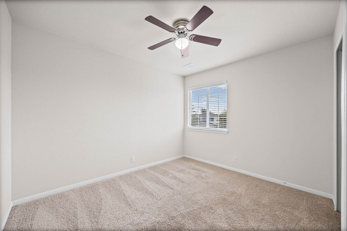 336 Celery Loop Austin, TX 78748 - Photo 13 of 32 Empty room with carpet flooring and a ceiling fan