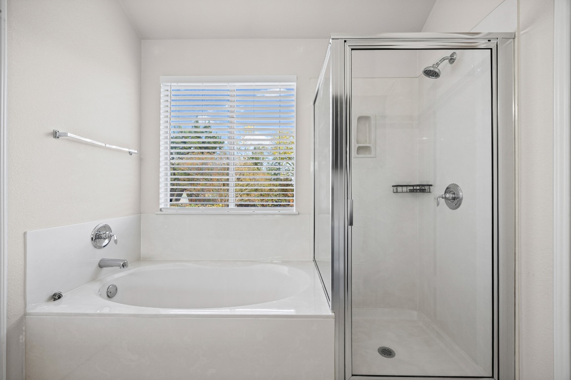 336 Celery Loop Austin, TX 78748 - Photo 19 of 32 Bathroom with a garden tub and a stall shower
