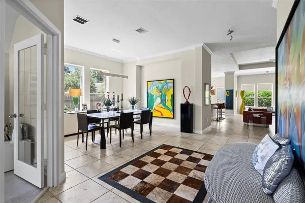 a dining room with furniture and a rug