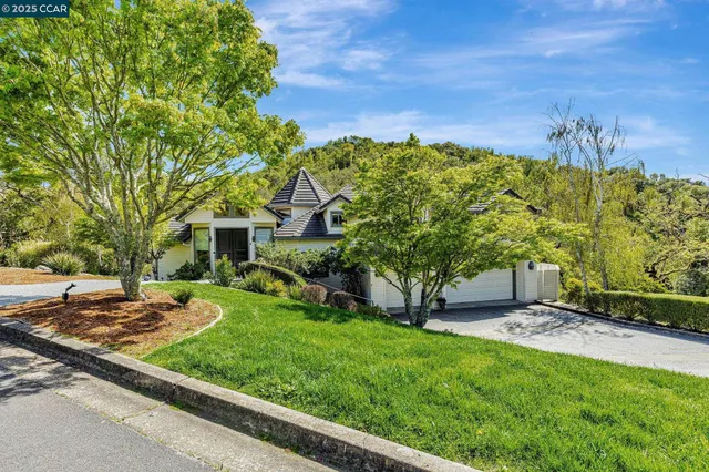 an aerial view of residential houses with outdoor space and river