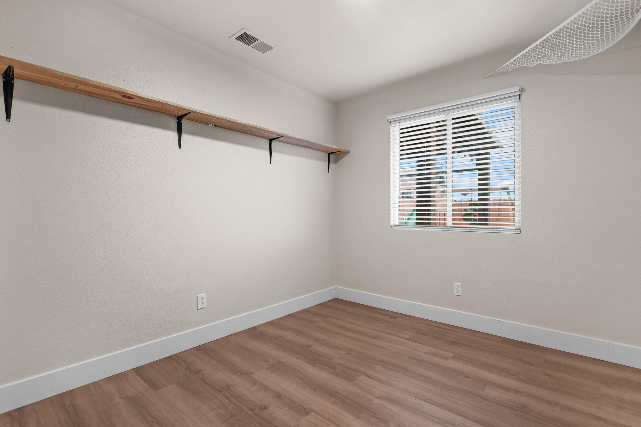 2132 Reta Way Red Bluff, CA 96080 - Photo 11 of 43 a view of a room with wooden floor and windows