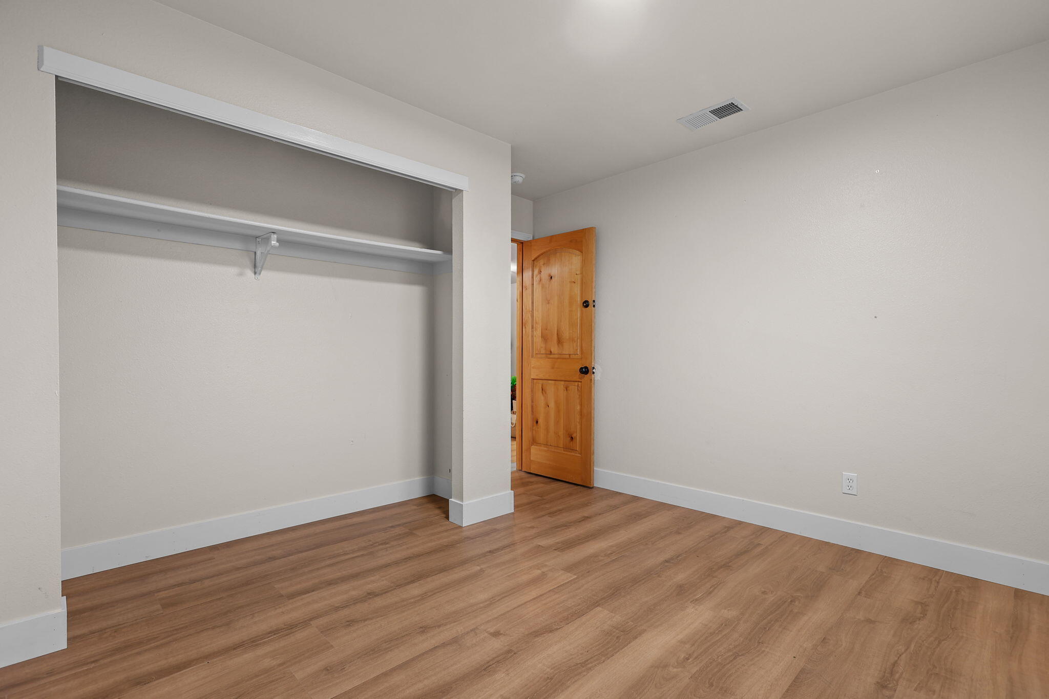 2132 Reta Way Red Bluff, CA 96080 - Photo 19 of 43 a view of an empty room with wooden floor and closet