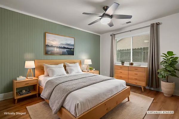 a bedroom with a large bed and a potted plant
