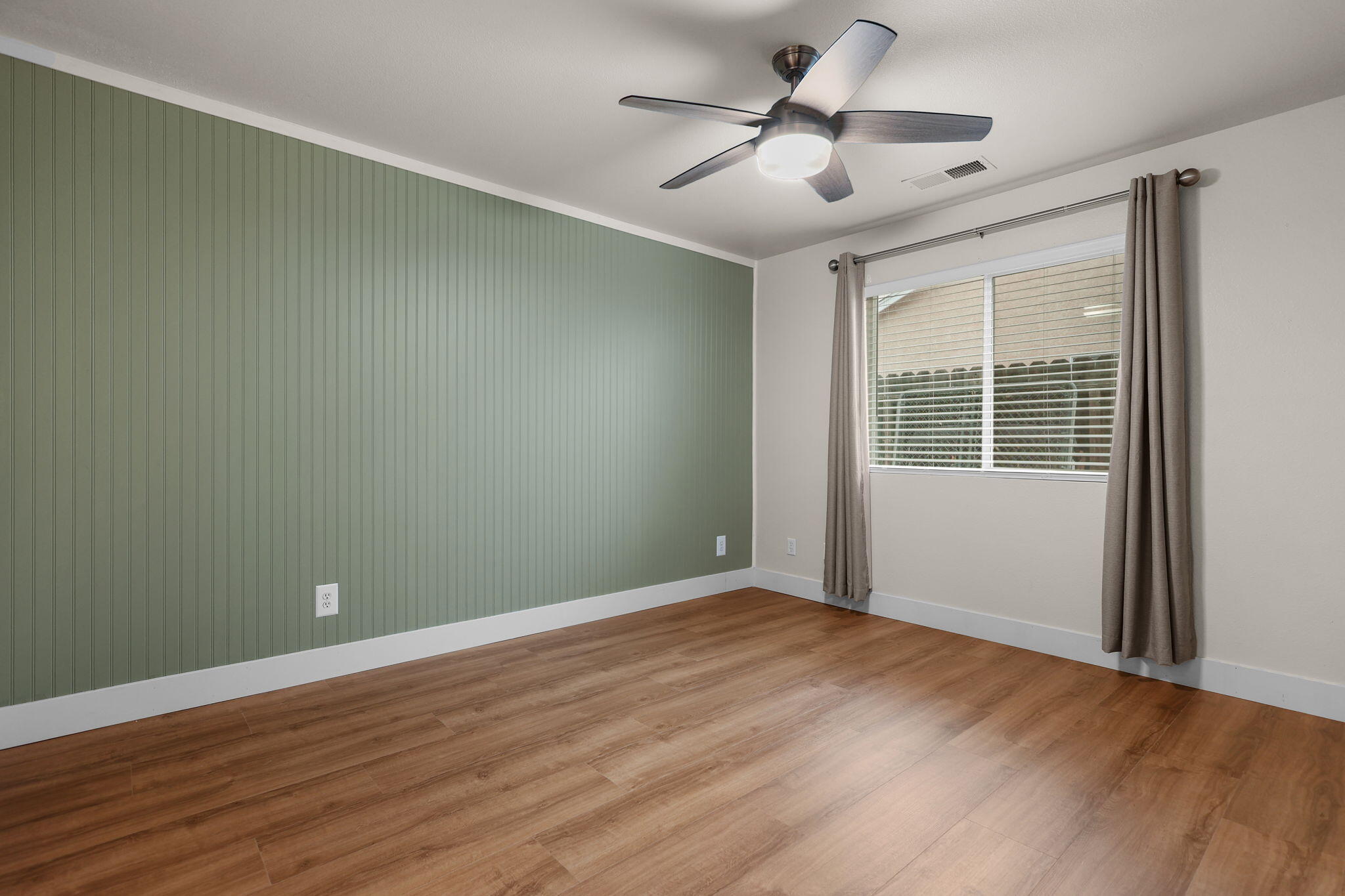 2132 Reta Way Red Bluff, CA 96080 - Photo 21 of 43 a view of a big room with wooden floor and windows