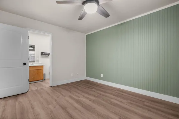 a view of a room with wooden floor