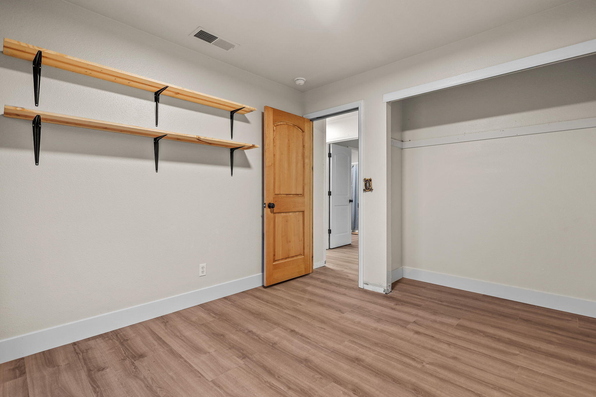 2132 Reta Way Red Bluff, CA 96080 - Photo 25 of 43 a view of empty room with wooden floor