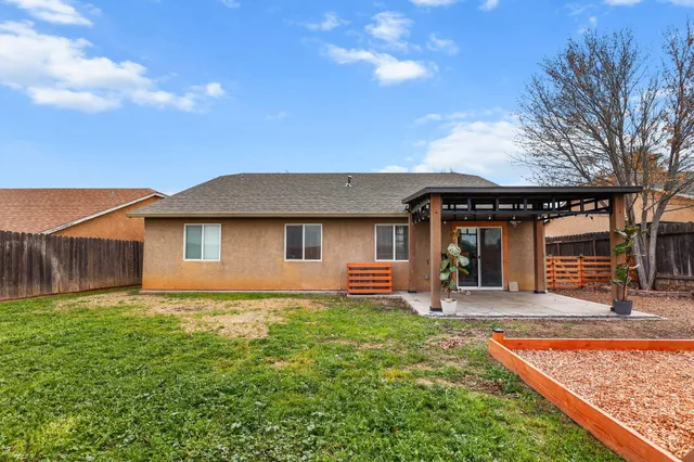 a front view of a house with patio yard and trees