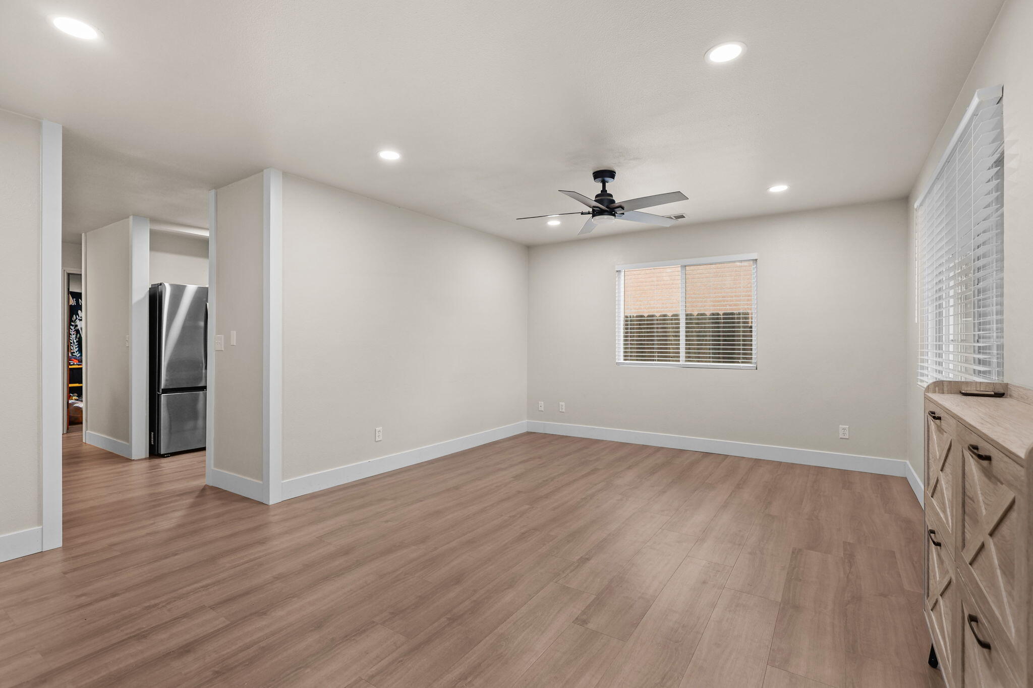 2132 Reta Way Red Bluff, CA 96080 - Photo 3 of 43 a view of an empty room with a window and wooden floor