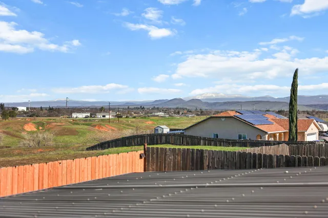 a view of swimming pool with outdoor seating and yard in the back