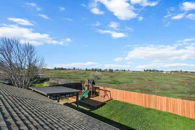 a view of a lake with couches in the patio