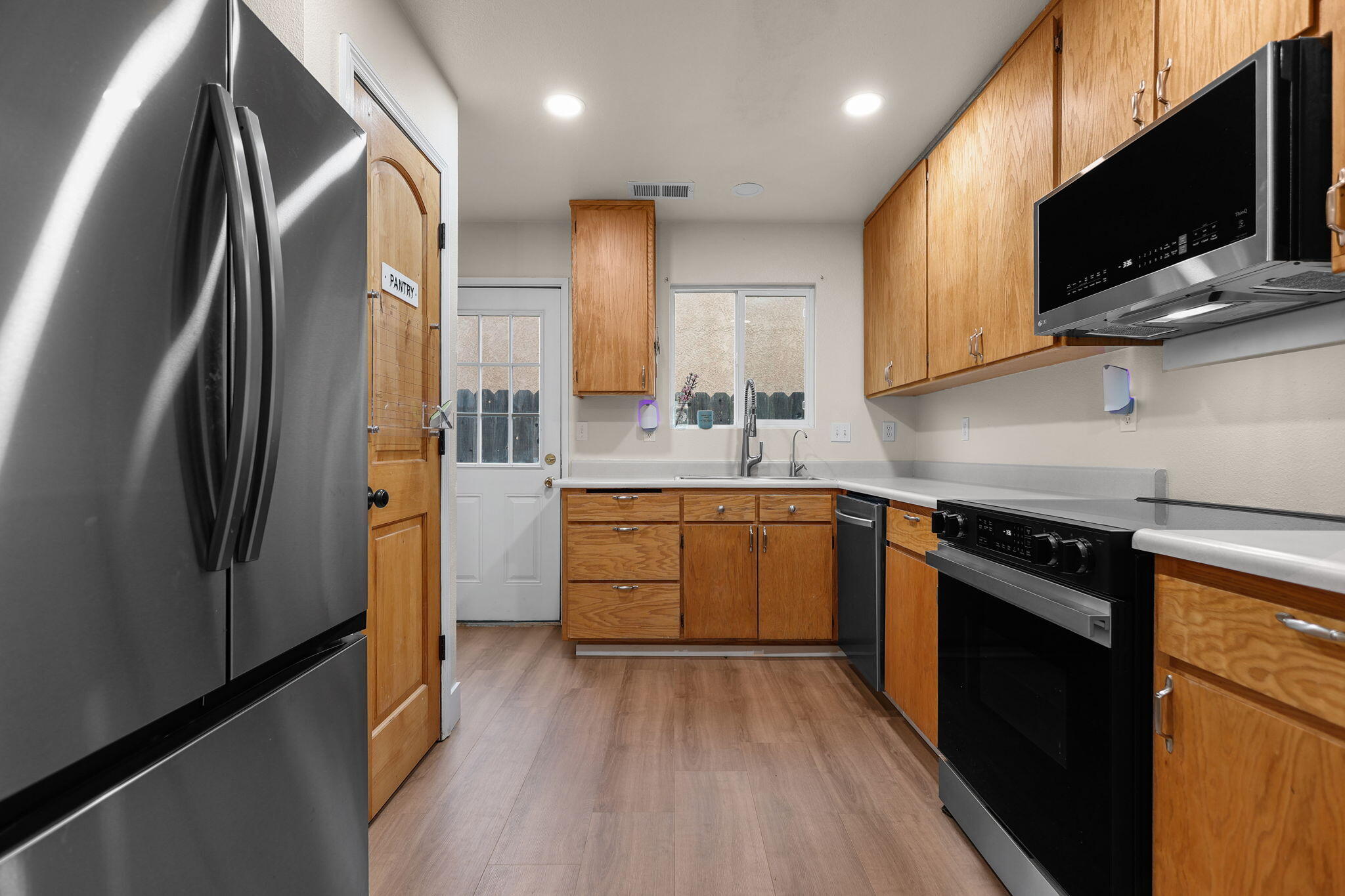 2132 Reta Way Red Bluff, CA 96080 - Photo 5 of 43 a kitchen with stainless steel appliances a refrigerator sink and microwave