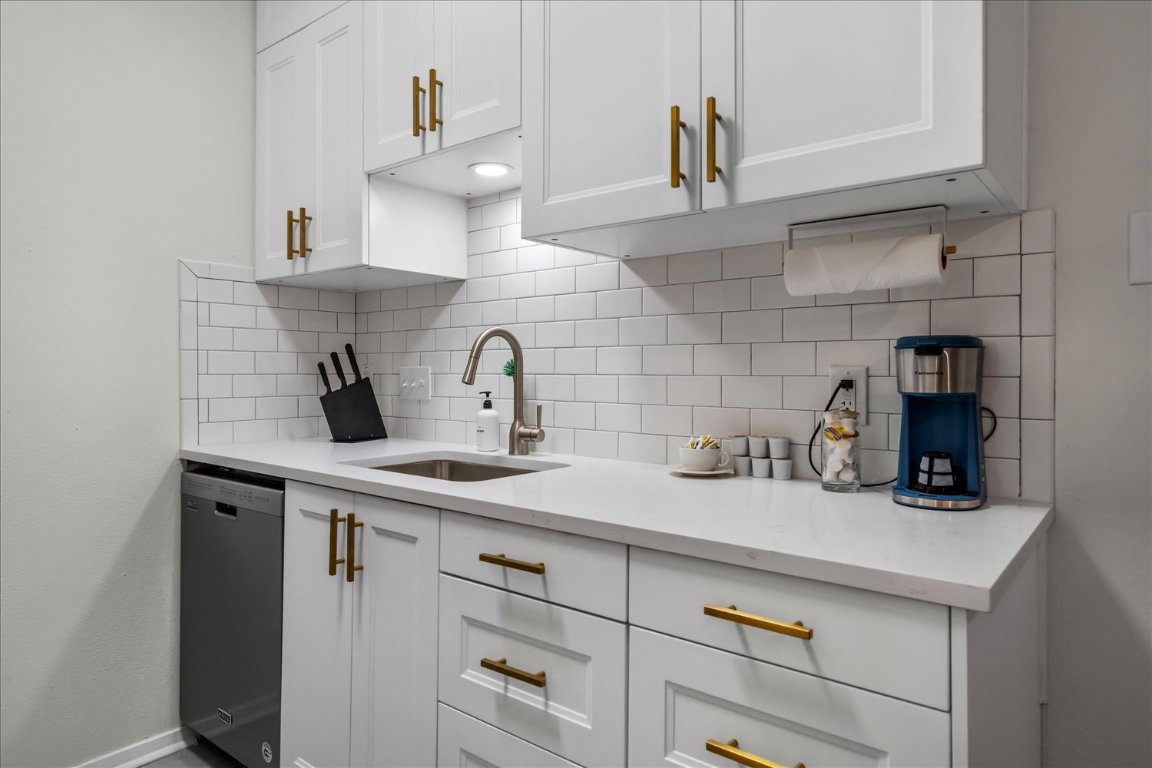 3316 Guadalupe Street, Unit 310 Austin, TX 78705 - Photo 14 of 38 a kitchen with a sink a cabinets and window