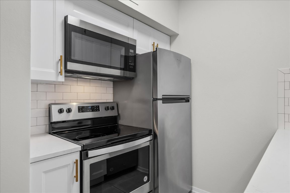 3316 Guadalupe Street, Unit 310 Austin, TX 78705 - Photo 15 of 38 a kitchen with a stove microwave and refrigerator