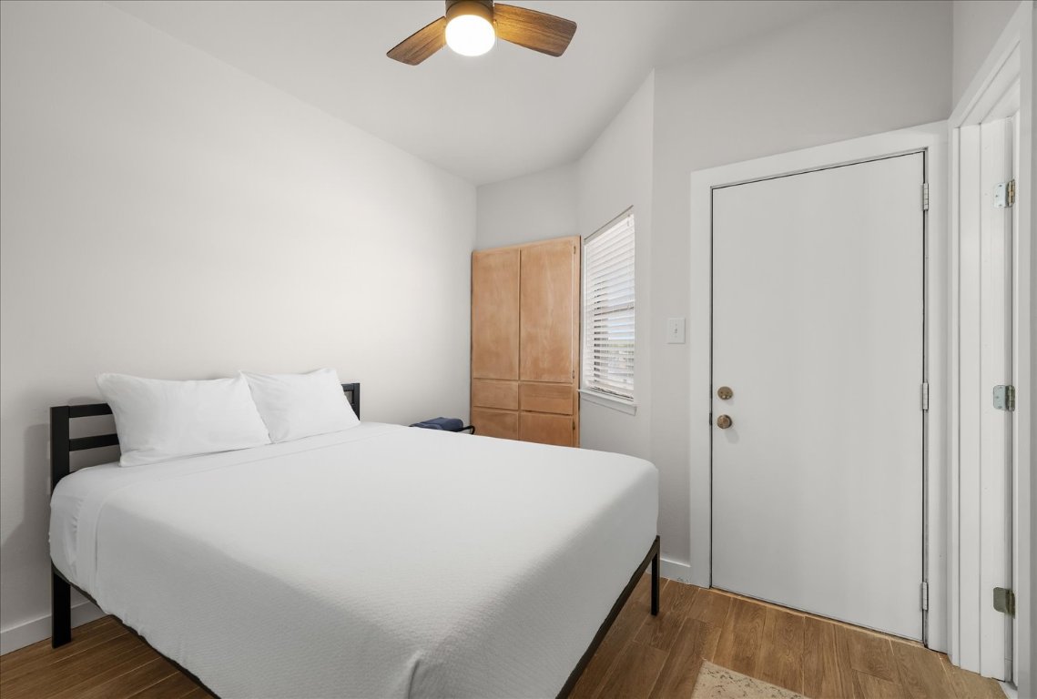 3316 Guadalupe Street, Unit 310 Austin, TX 78705 - Photo 19 of 38 a bedroom with a bed and a chandelier